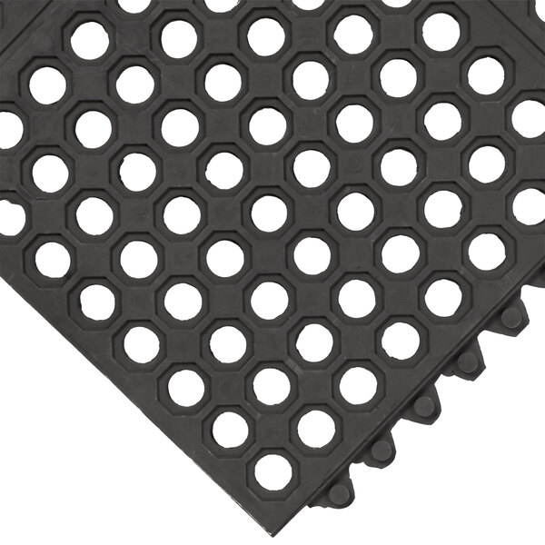 A black rubber Cactus Mat with holes on the top.