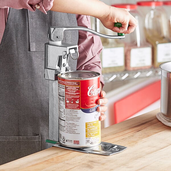 A person using a Garde XL heavy-duty manual can opener to open a can of food.