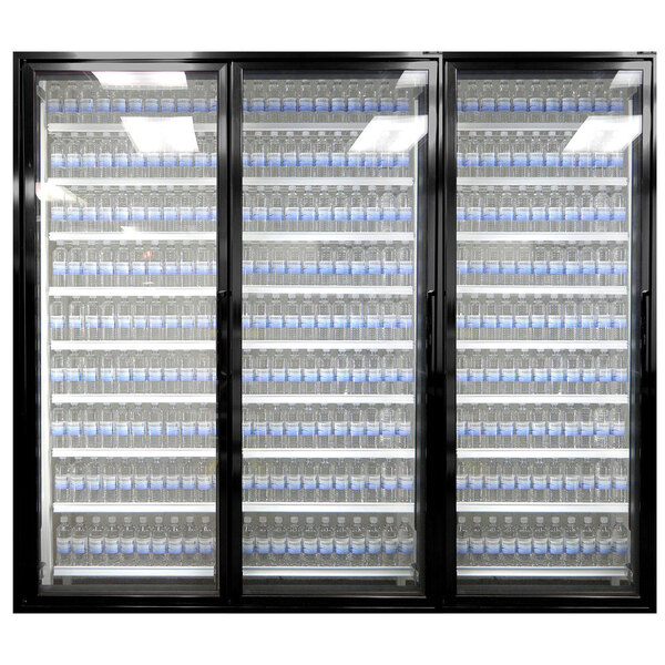 A white Styleline walk-in freezer merchandiser door with glass shelving holding rows of bottles of water.