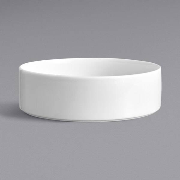 A Oneida Scandi bright white porcelain bowl with a grey background.