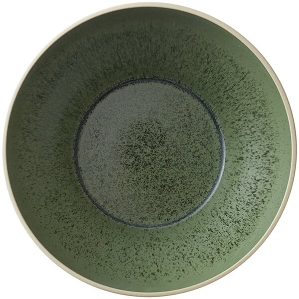 A green Oneida Moira stoneware bowl with black speckles.