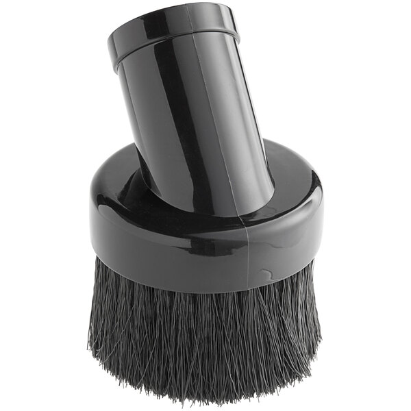 A black circular dusting brush with a black handle.
