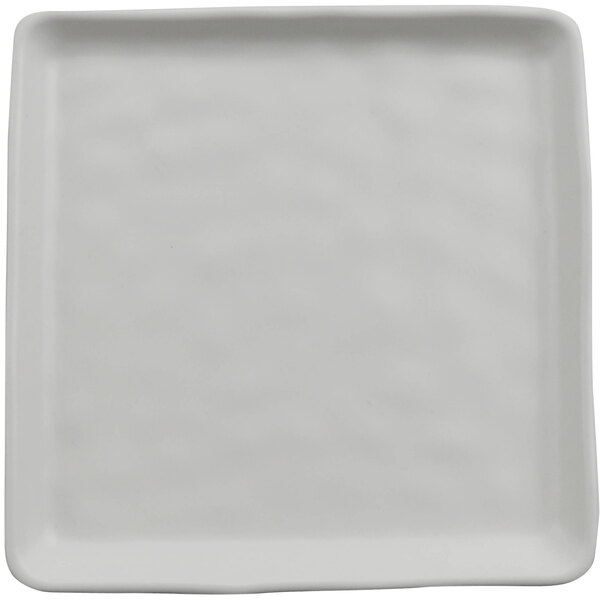 A white cheforward square melamine plate with a textured surface and a small rim.