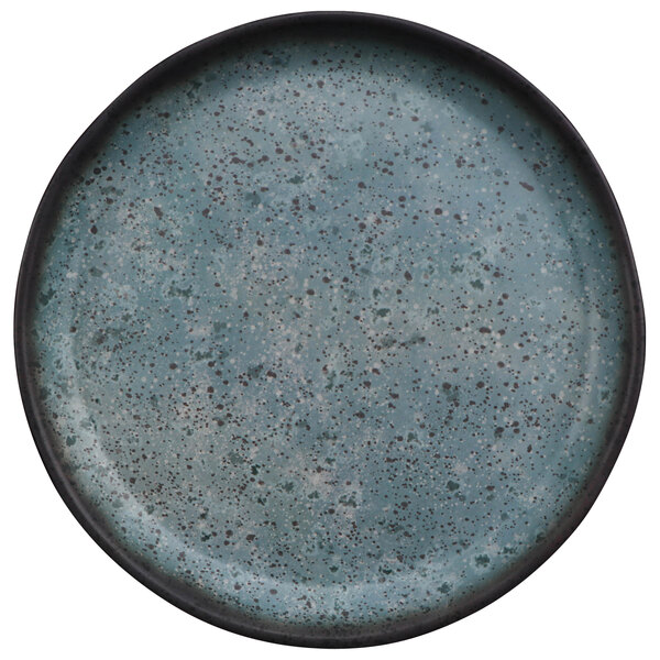 A close up of a cheforward by GET Savor round blue melamine plate with a speckled design.