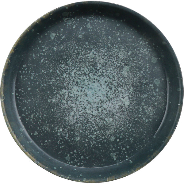 A round black cheforward melamine plate with speckled paint in dusk and spruce colors.