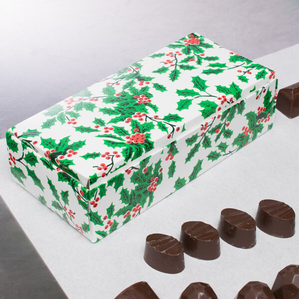 A white 1 lb. Holly candy box filled with chocolates.