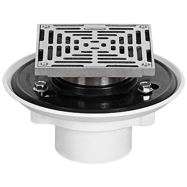A white Josam floor drain with a Nikaloy metal grate over the drain.