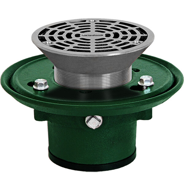 A close-up of a Josam 8" round adjustable cast iron floor drain with a green and silver Nikaloy strainer.