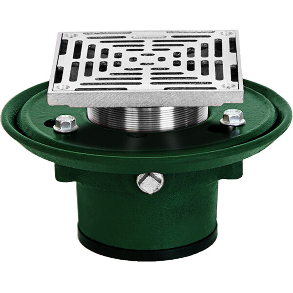 A green and silver Josam floor drain with a metal plate over a hole.