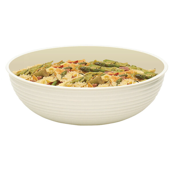 A white Cambro round ribbed bowl filled with pasta and asparagus.