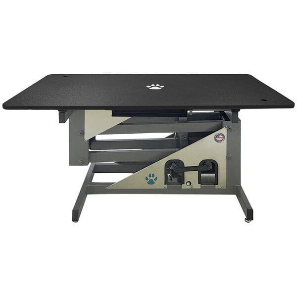 A black rectangular grooming table with a paw print on it.