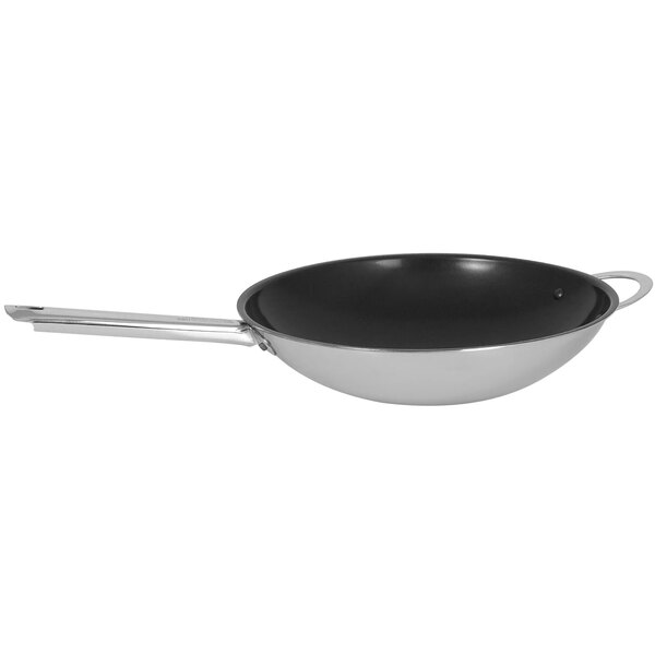A close-up of a black and white Spring USA Vulcano round bottom wok with a helper handle.