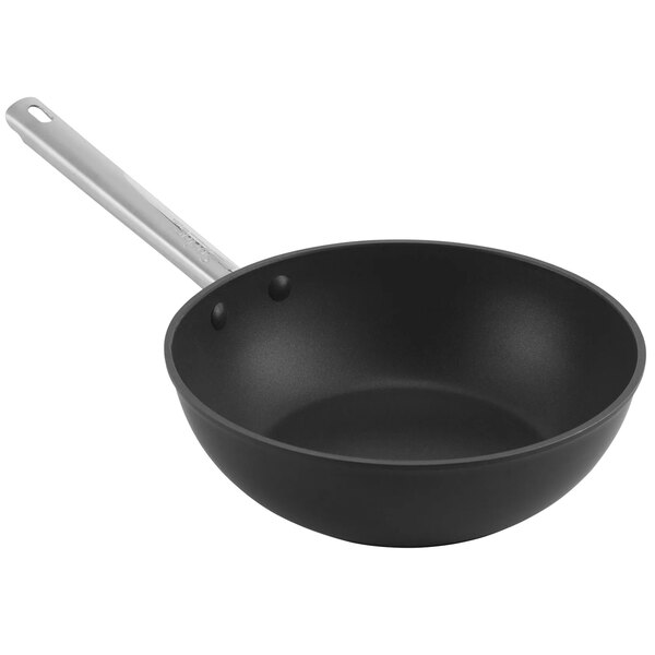 A black Spring USA flat bottom wok with a stainless steel handle.