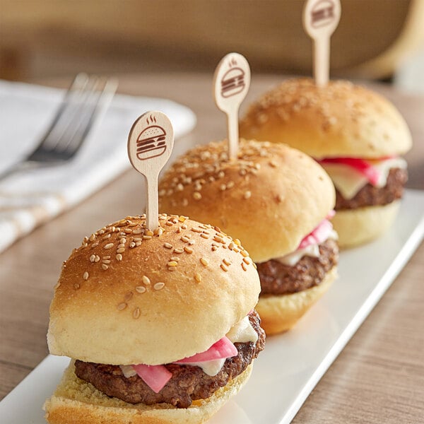 Customizable round picks in mini burgers on a white plate.