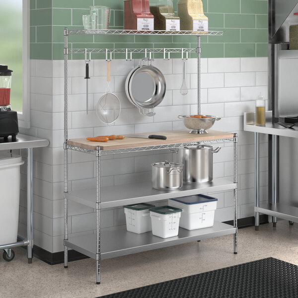 A kitchen with a Regency stainless steel baker's rack with utensils on a counter.