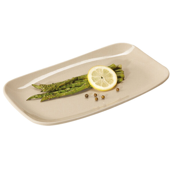 A rectangular bamboo melamine platter with asparagus and a lemon slice on it.