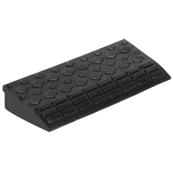 A black rectangular rubber corner ramp with a pattern.