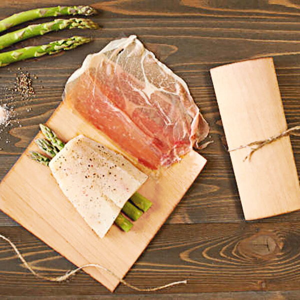 Wildwood Grilling wraps with asparagus and meat on a cutting board.