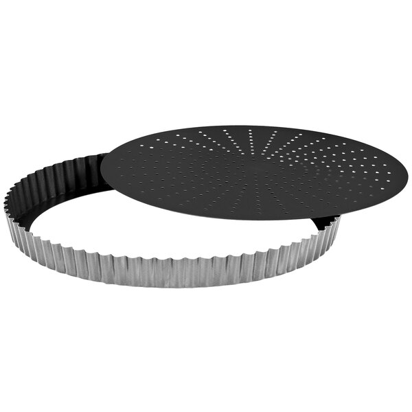 A black and silver Gobel round fluted tart pan with holes.