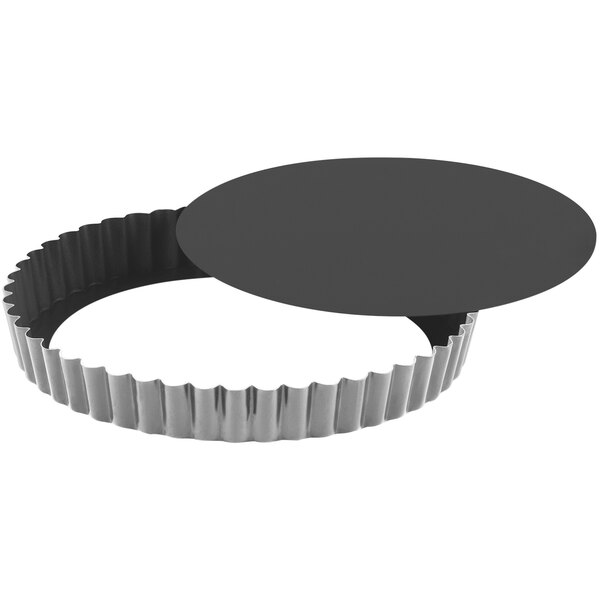 A round metal Gobel tart pan with a black non-stick surface.