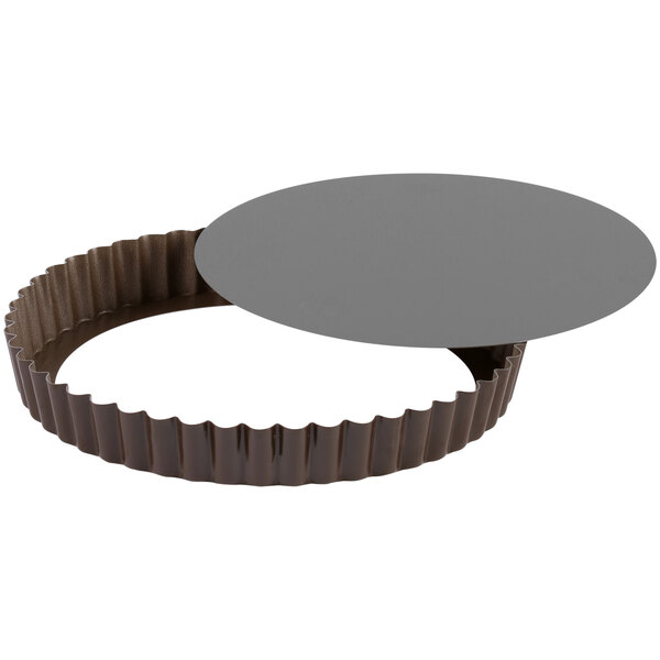 A Gobel round fluted tart pan with a removable bottom.