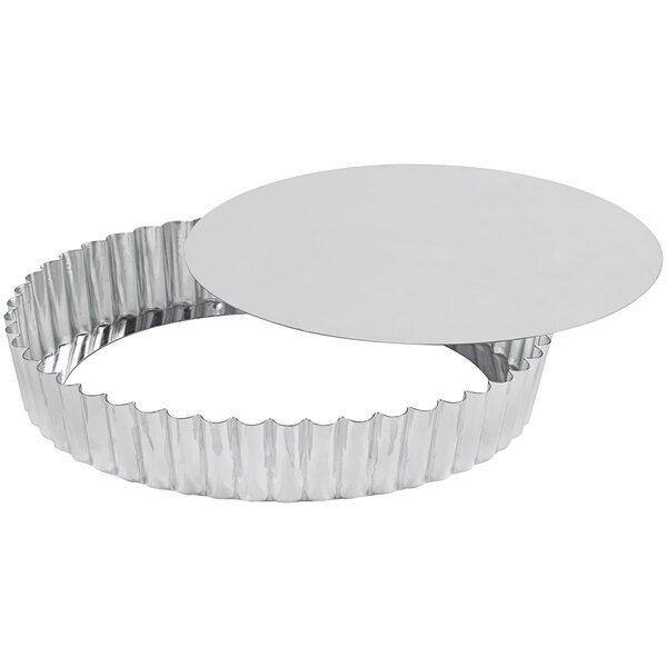 A silver tart pan with a removable bottom.