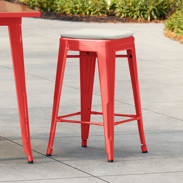 Lancaster Table & Seating Alloy Series Ruby Red Outdoor Backless Counter Height Stool with Tan Fabric Magnetic Cushion
