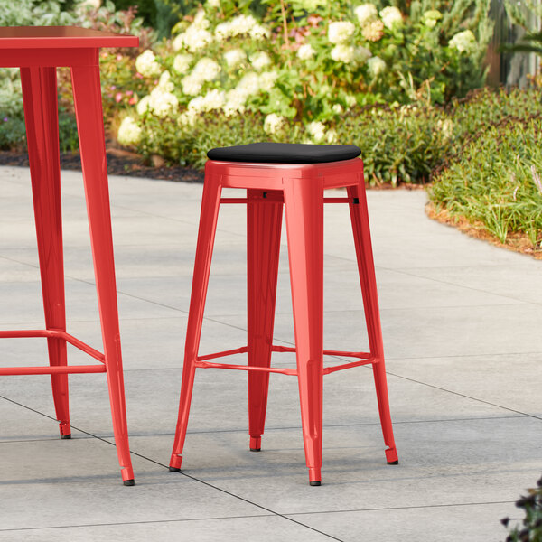 Lancaster Table & Seating Alloy Series Ruby Red Outdoor Backless Barstool with Black Fabric Magnetic Cushion