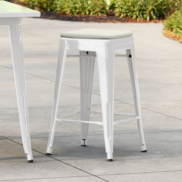 Lancaster Table & Seating Alloy Series White Outdoor Backless Counter Height Stool with Tan Fabric Magnetic Cushion