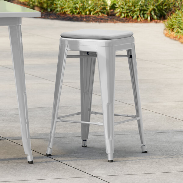 Lancaster Table & Seating Alloy Series Silver Outdoor Backless Counter Height Stool with Gray Fabric Magnetic Cushion