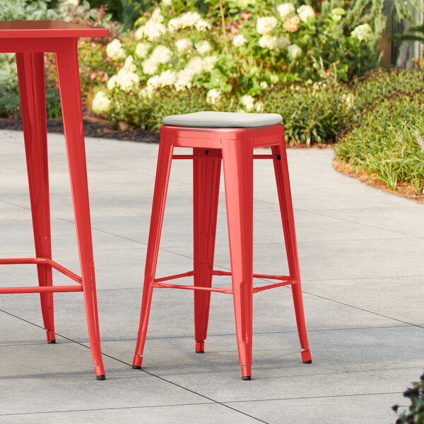 Lancaster Table & Seating Alloy Series Ruby Red Outdoor Backless Barstool with Tan Fabric Magnetic Cushion