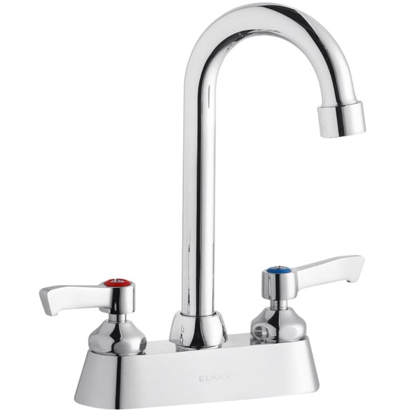 A silver Elkay deck-mount faucet with red lever handles.