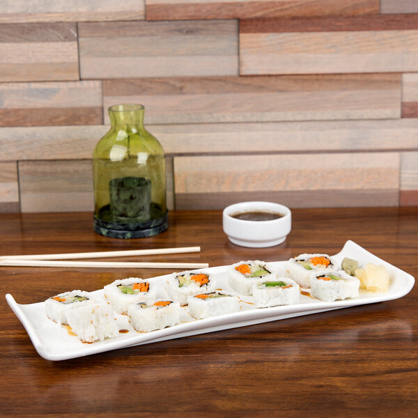 An American Metalcraft white porcelain serving platter with sushi rolls on it.