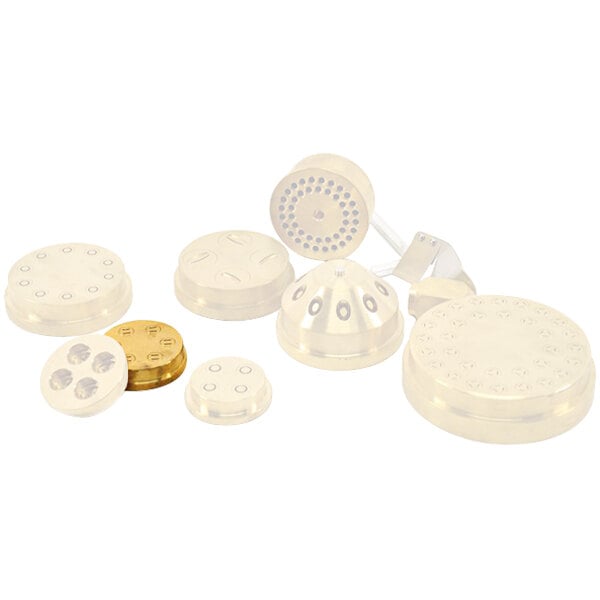 A group of white circular plastic parts with holes.