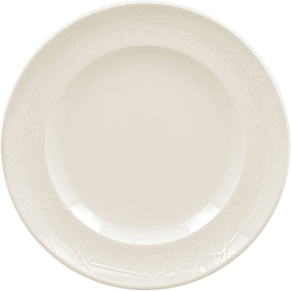 A close-up of a white RAK Porcelain flat plate with an embossed design on it.