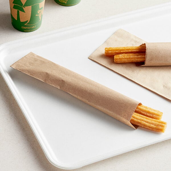 Bagcraft brown paper wrapper with churros on a white tray.