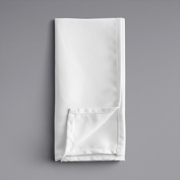 A folded white Oxford cloth napkin.