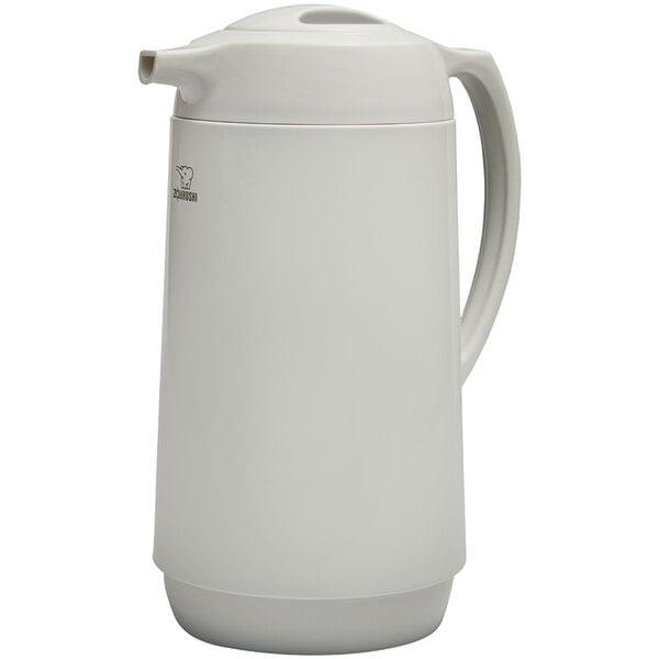 A white Zojirushi glass-lined coffee carafe with a twist open stopper.