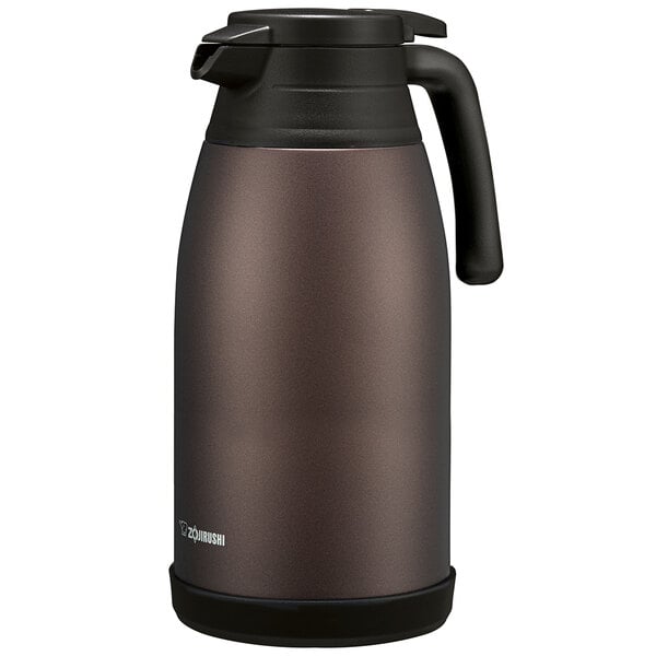 A brown Zojirushi stainless steel vacuum carafe with a handle and screw off lid.