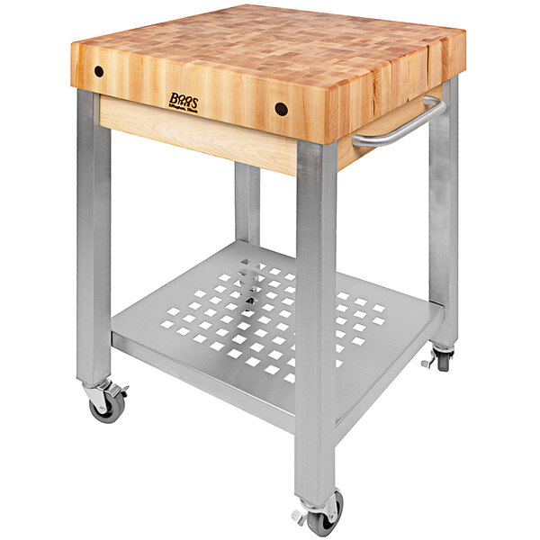 A John Boos Cucina Technica maple cart with a wood cutting board on a metal stand.