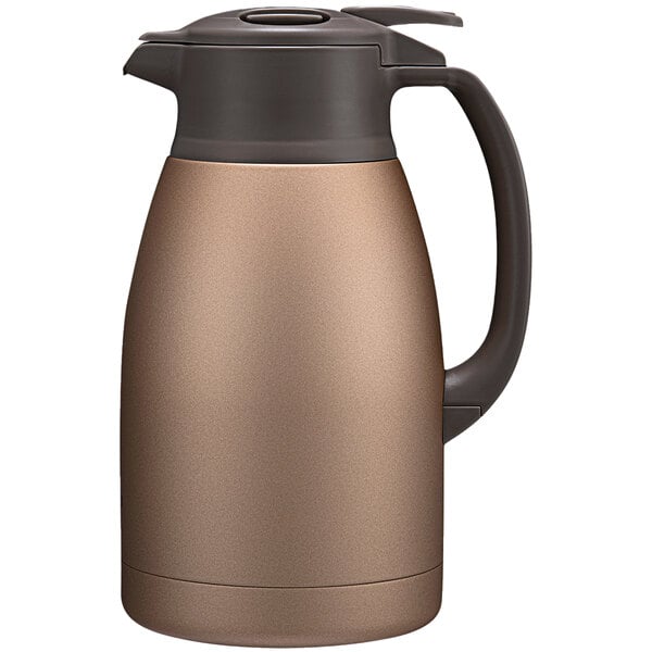 A Zojirushi stainless steel vacuum carafe with a black handle.