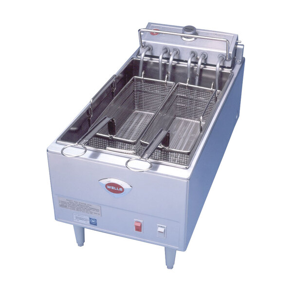 A Wells commercial fryer with two baskets on a counter.
