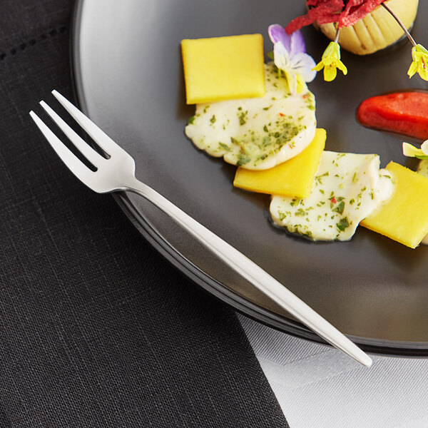A plate of food with an Acopa brushed stainless steel oyster fork.