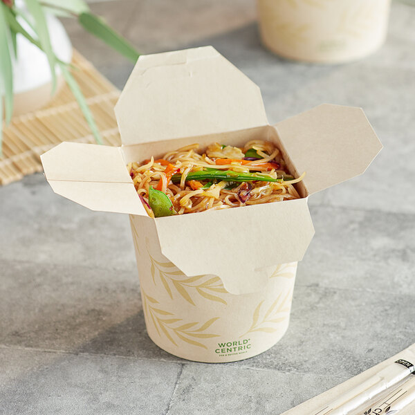 A World Centric Asian take-out container filled with noodles and chopsticks.