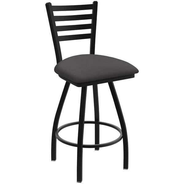 A black Holland Bar Stool ladderback swivel bar stool with a grey cushion.