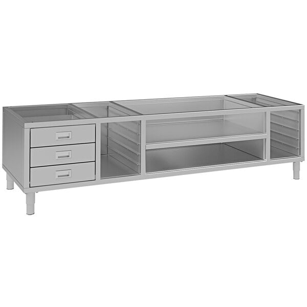 A silver metal Mibrasa Parrilla grill stand with drawers.
