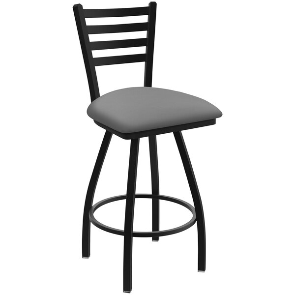 A black Holland Bar Stool Ladderback swivel bar stool with a grey seat.
