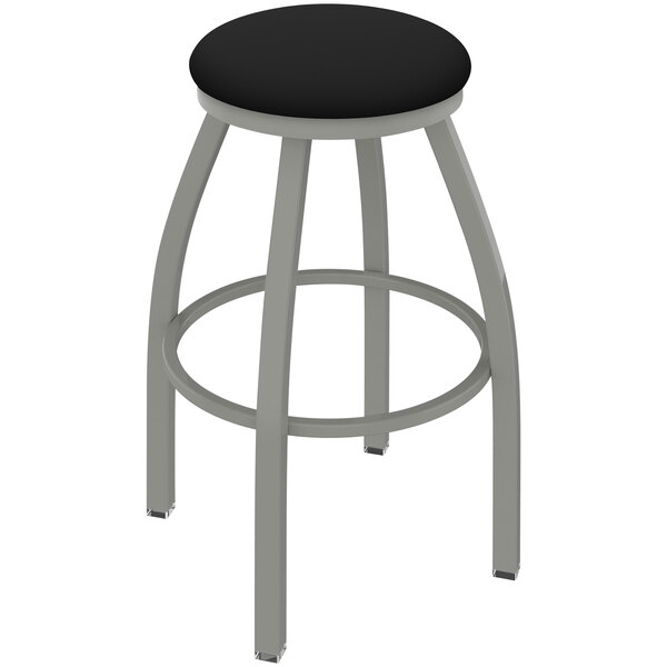 A grey Holland Bar Stool ladderback swivel bar stool with a black vinyl seat and anodized nickel finish.