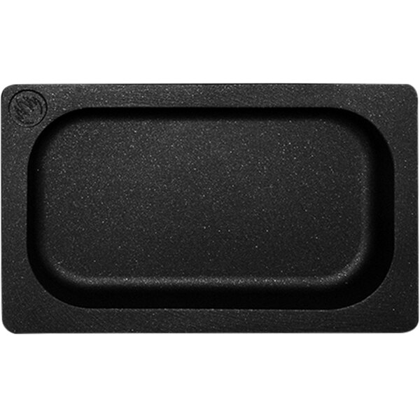 A black rectangular Mibrasa cast aluminum roasting tray with a white border.