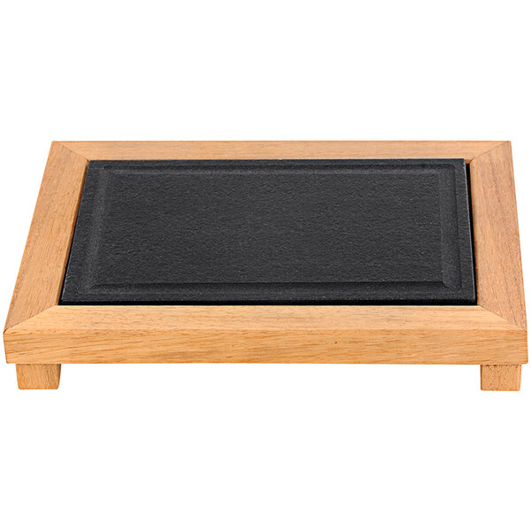 A wooden rectangular slab with a black granite surface on a black tray with a wooden frame.